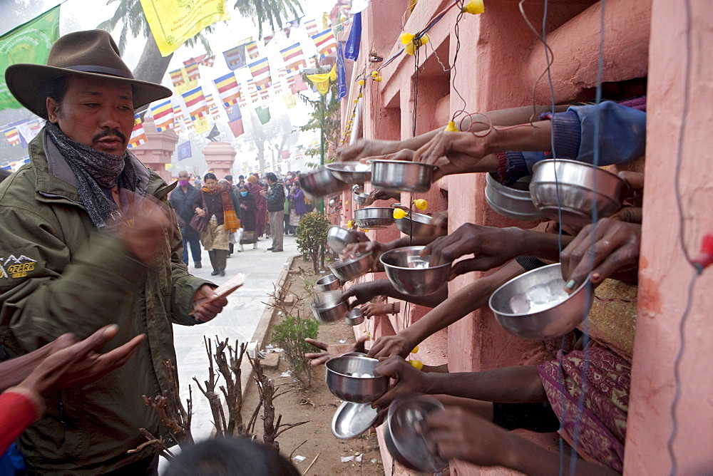 While circumambulating maha bodhi temple, tibetans making money offerings to bihari in need. Kalachakra initiation in bodhgaya, india  