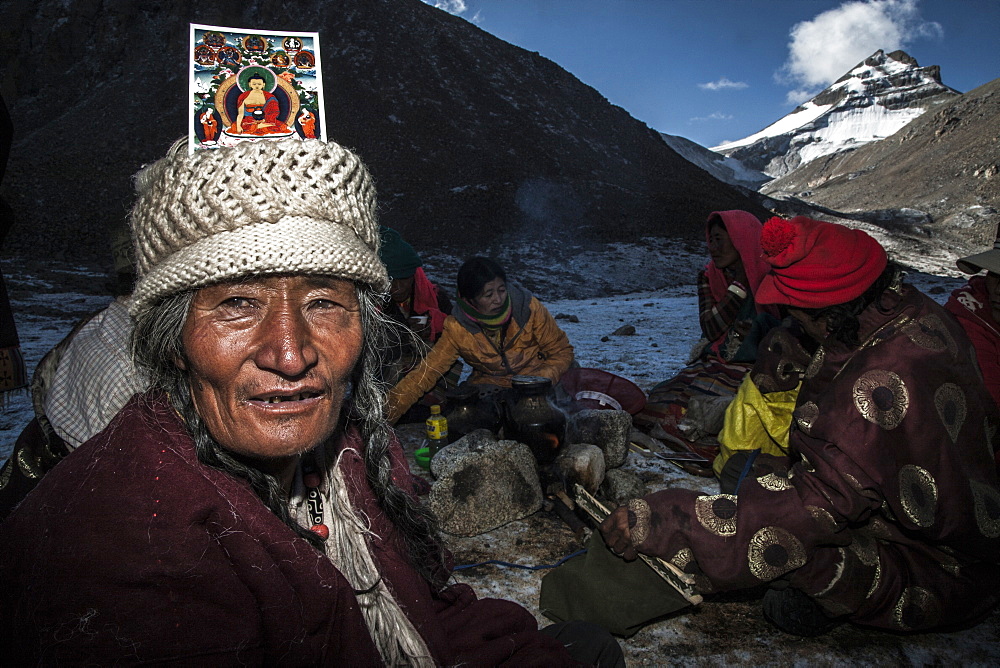 Pilgrim with a Buddha card on head at Dirapuk over Zutul Puk, Tibet, China, Asia