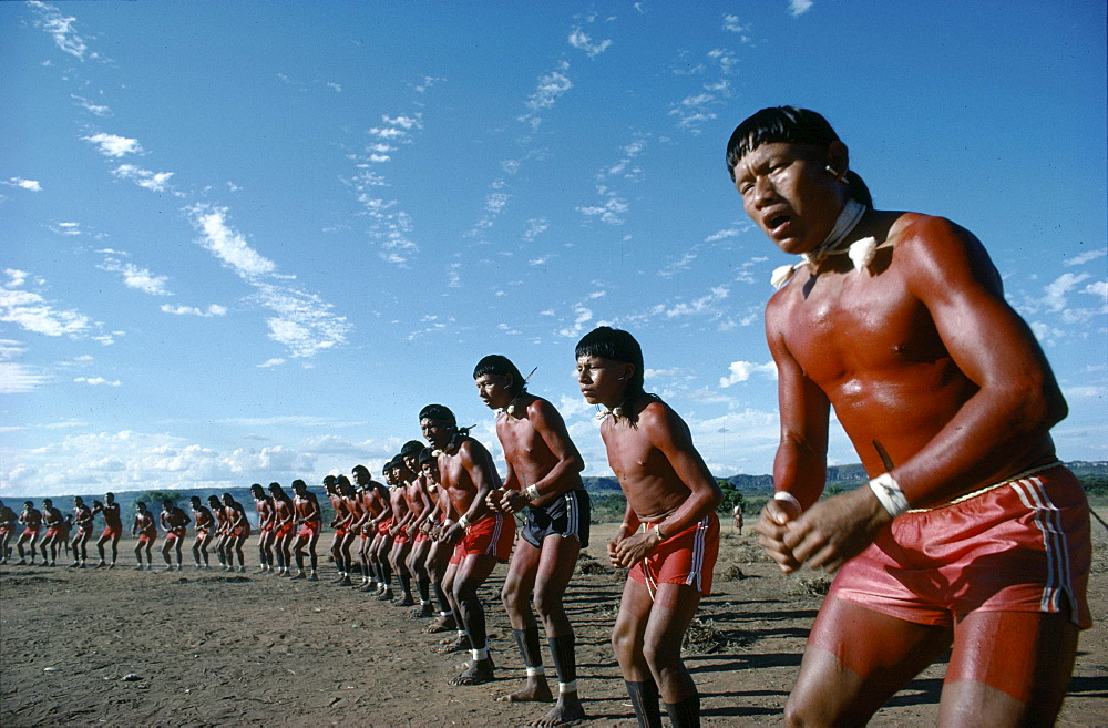 Xavante warriors prepare to wrestle wooden poles, a of taming or harnessing dark jungle forests. Brazil