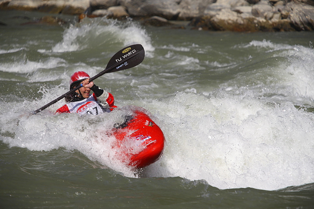 Paddler performing freestyle routines on a set wave. Trisuli, Nepal