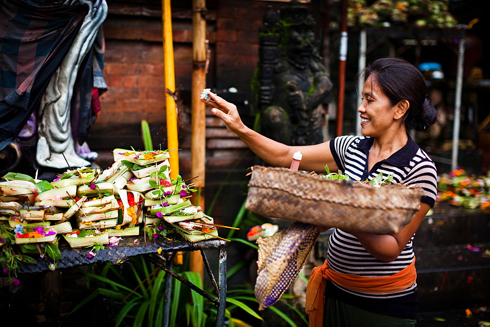 A lady gives her daily offering in Bali, Indonesia, Southeast Asia, Asia