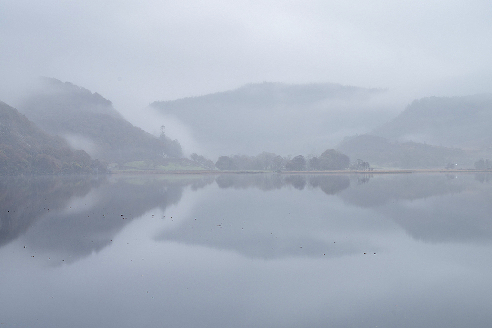 Dawn mist over Llyn Dinas in autumn, Snowdonia National Park (Eryri), Wales, United Kingdom