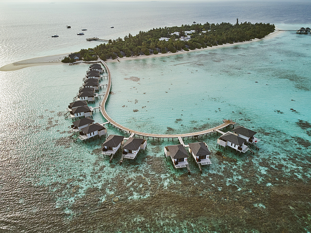 The shoreline and water villas of a tropical paradise island in the Maldives: Havodda Island, Gaafu Dhaalu atoll, in the Maldives' far south, in the Indian Ocean.