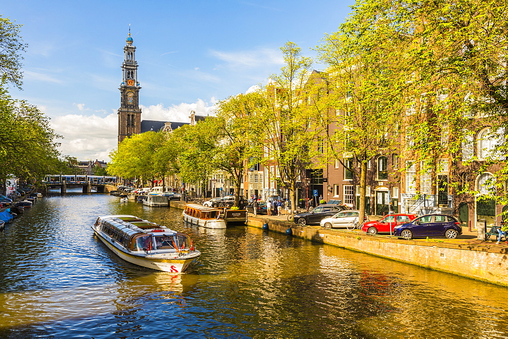 Boat on Prinsengracht Canal, with Westerkerk in the background, Amsterdam, Netherlands, Europe