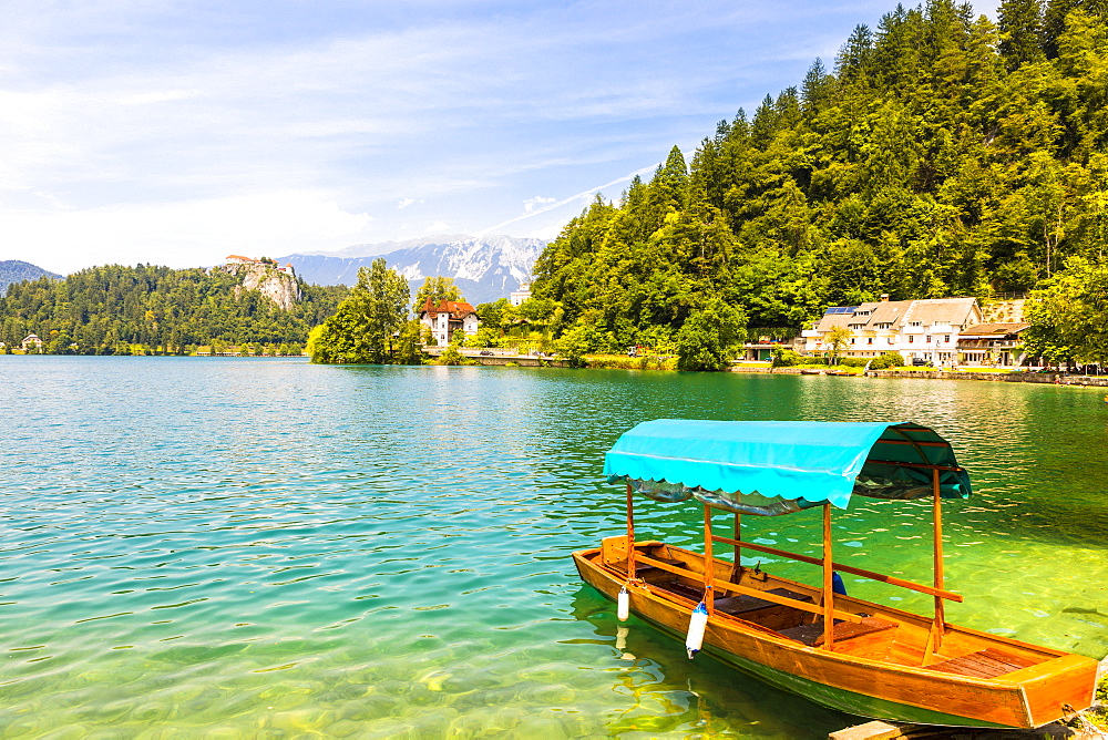 A boat on Lake Bled with Bled Castle in the background, Lake Bled, Slovenia, Europe