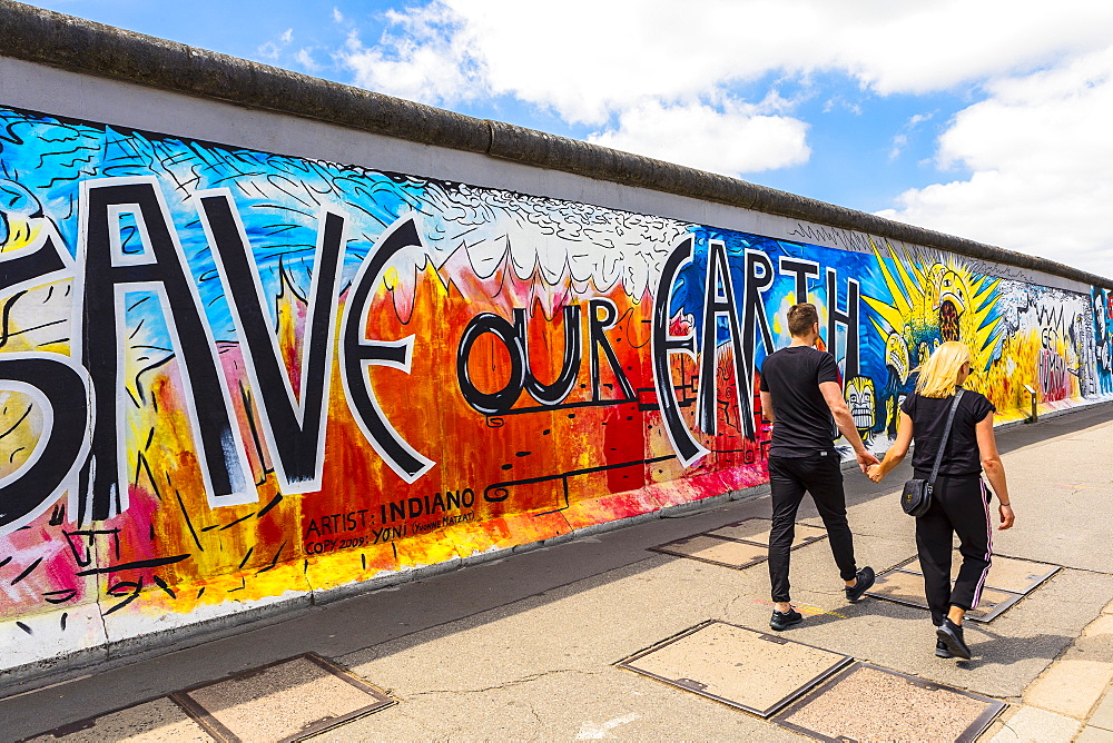 People walking in front of the Berlin Wall, Berlin, Germany, Europe