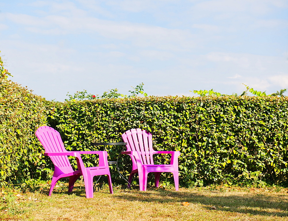 Two pink chairs in a French garden, France, Europe