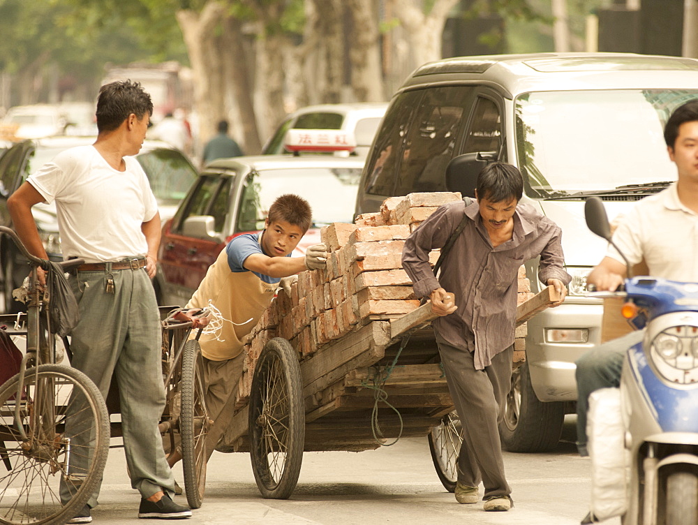 Busy street scene, showing the traditional and the new, Shanghai, China, Asia