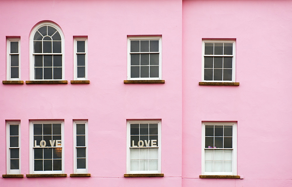 Pink house with love signs in the window, United Kingdom, Europe