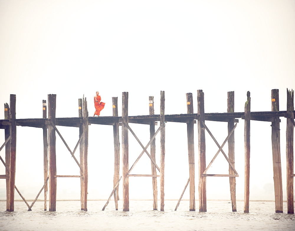 Monk crossing the U Bein Bridge, Taungthaman Lake, Amarapura near Mandalay, Myanmar (Burma), Asia