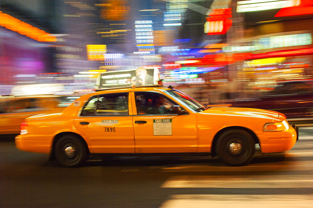 Traditional yellow taxi at night, New York City, United States of America, North America