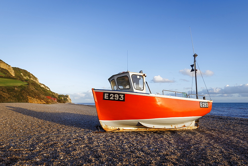 Fishing boat moored on Branscombe Beach at sunset, Seaton, East Devon, England, United Kingdom, Europe