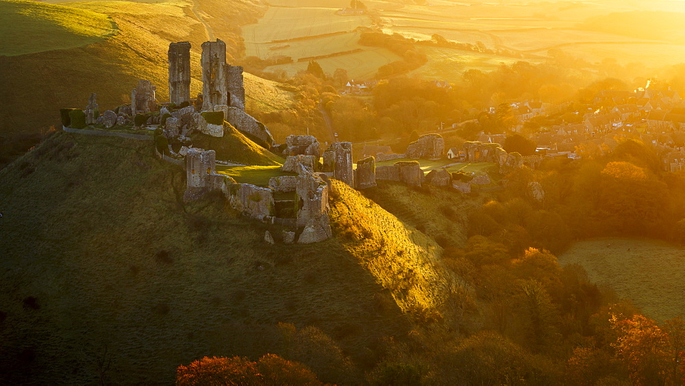 Golden sunrise over the village and castle at Corfe, Dorset, England, United Kingdom, Europe