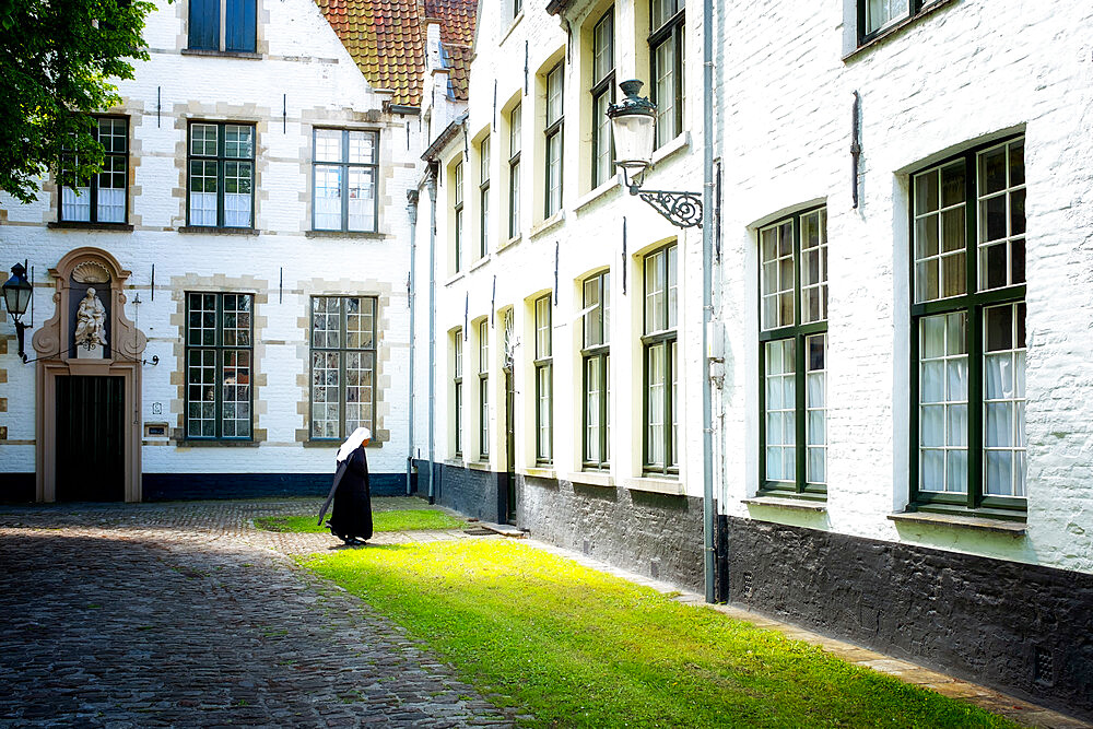 Nun at Begijnhof (Beguinage), Order of St. Benedict Convent, UNESCO World Heritage Site, Bruges, Belgium, Europe