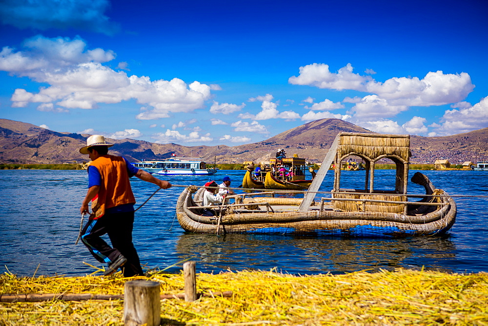 Quechua Indian family on Floating Grass islands of Uros, Lake Titicaca, Peru, South America