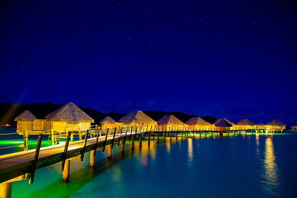 Overwater bungalows at night, Le Taha'a Resort, Tahiti, French Polynesia, South Pacific, Pacific