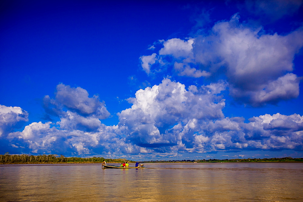 Family on a canoe, Amazon River, Iquitos, Peru, South America