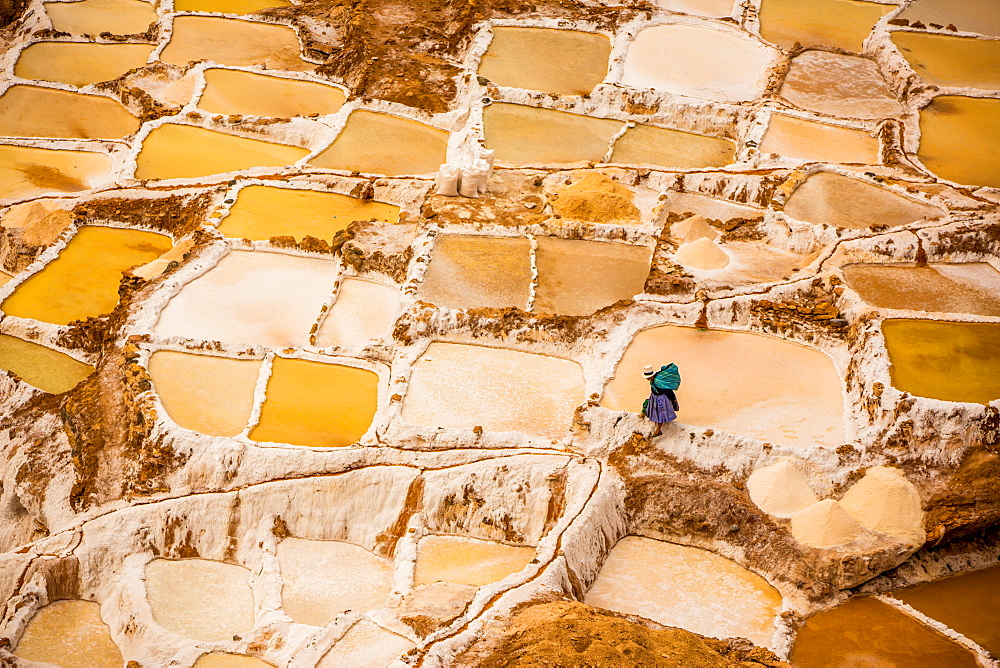 Woman mining salt, Salineras de Maras, Maras Salt Flats, Sacred Valley, Peru, South America