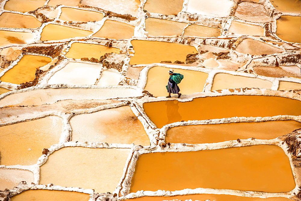 Woman mining salt, Salineras de Maras, Maras Salt Flats, Sacred Valley, Peru, South America