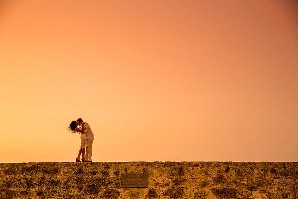 Couple posing on the old wall, Old Walled-in City, Cartagena, Colombia, South America