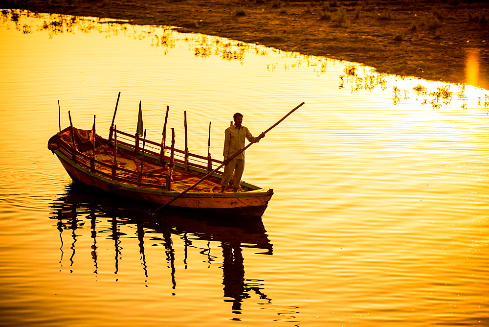 Silhouette of Indian gondolier during the Flower Holi Festival, Vrindavan, Uttar Pradesh, India, Asia