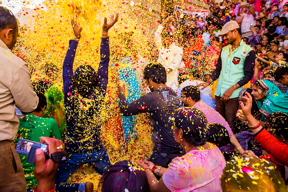 Crowd throwing flower petals during the Flower Holi Festival, Vrindavan, Uttar Pradesh, India, Asia