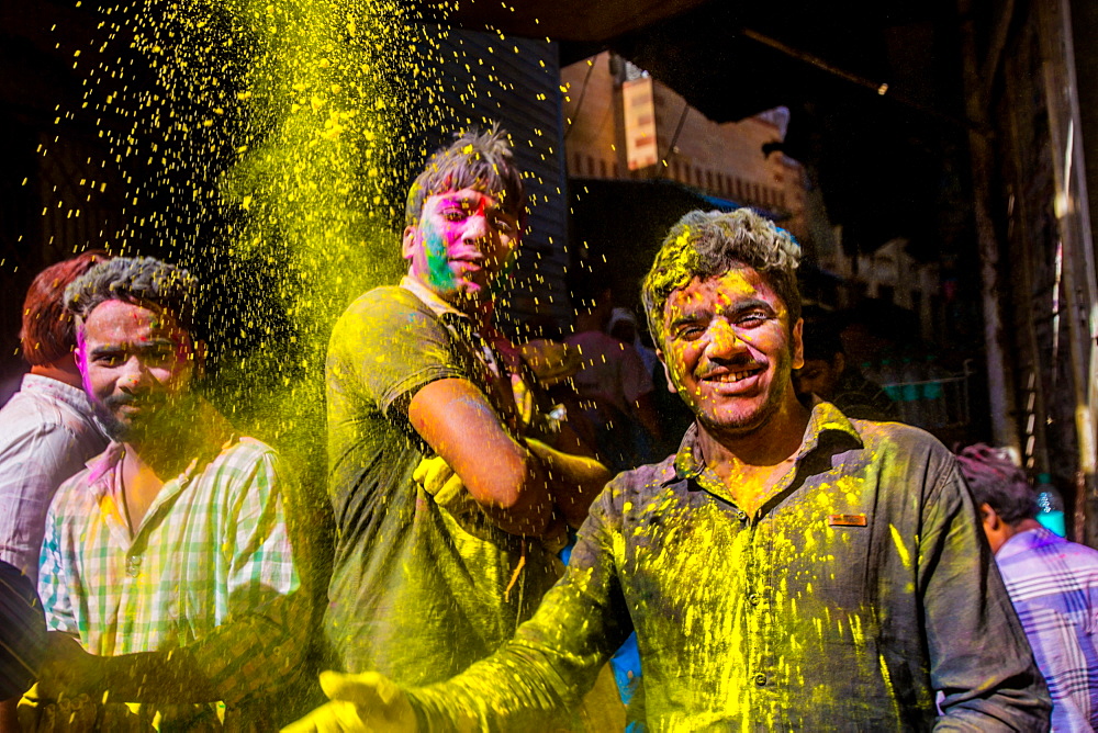 Men throwing yellow pigment, Holi Festival, Vrindavan, Uttar Pradesh, India, Asia