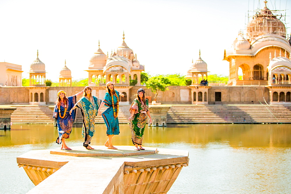 Female tourists stand in front of Temple during Holi Festival, Vrindavan, Uttar Pradesh, India, Asia