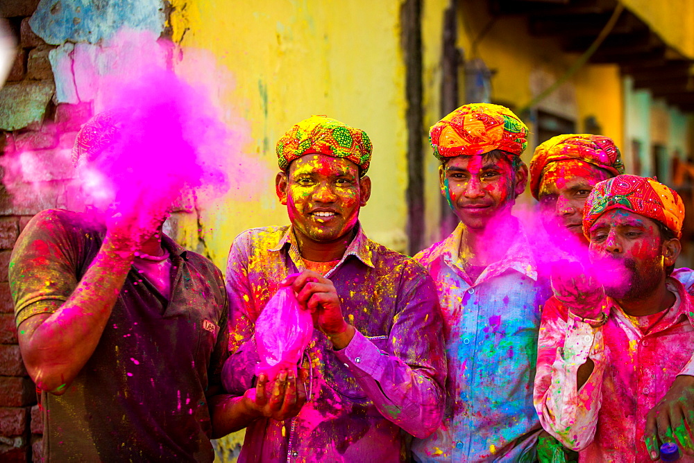 Men throwing colored pigment, Holi Festival, Vrindavan, Uttar Pradesh, India, Asia