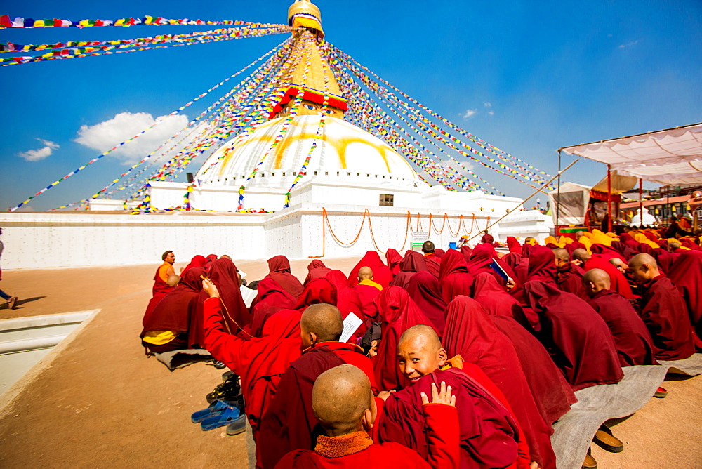 Buddhist monks praying around temple at Bouddha (Boudhanath), UNESCO World Heritage Site, Kathmandu, Nepal, Asia