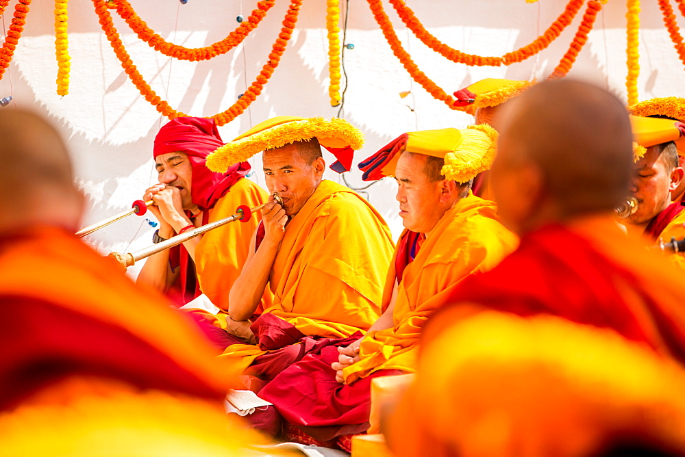 Buddhist Monks praying around temple at Bouddha (Bodhnath), Kathmandu, Nepal, Asia