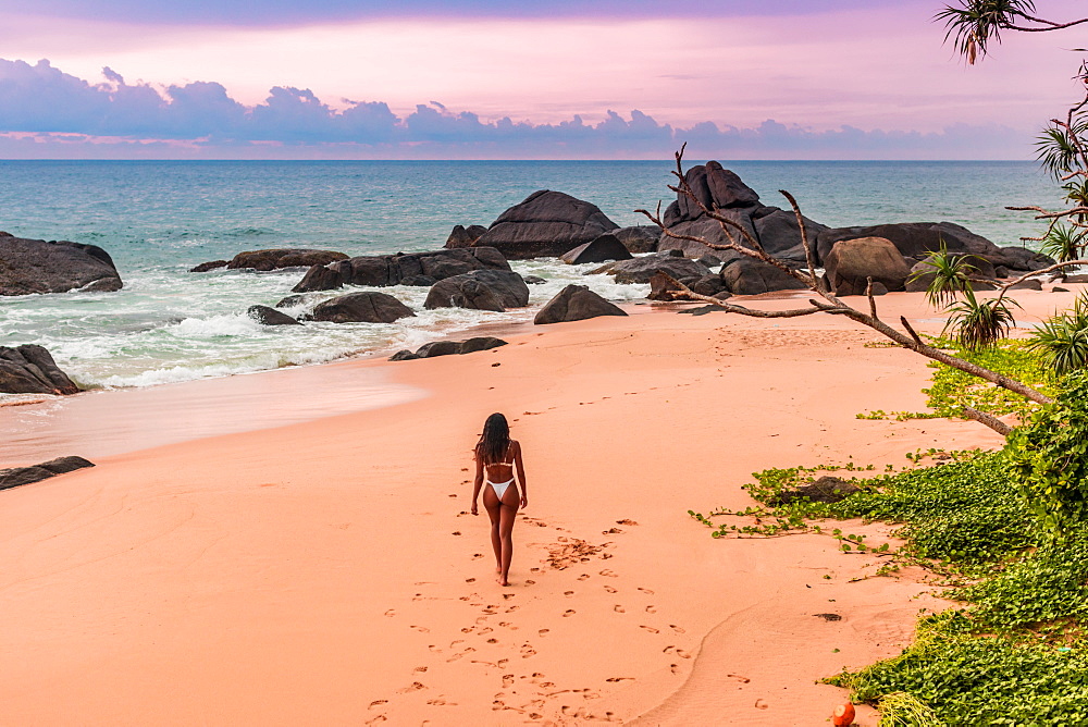 Model strolling on the beach before sunset at Kumu Beach, Sri Lanka, Asia