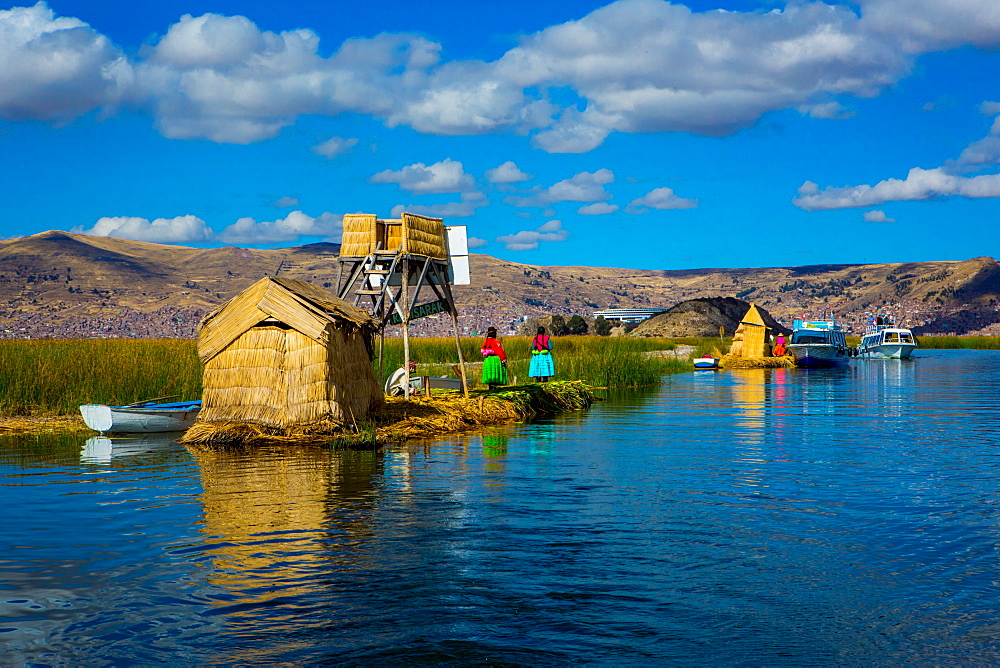 Quechua Indian family on Floating Grass islands of Uros, Lake Titicaca, Peru, South America