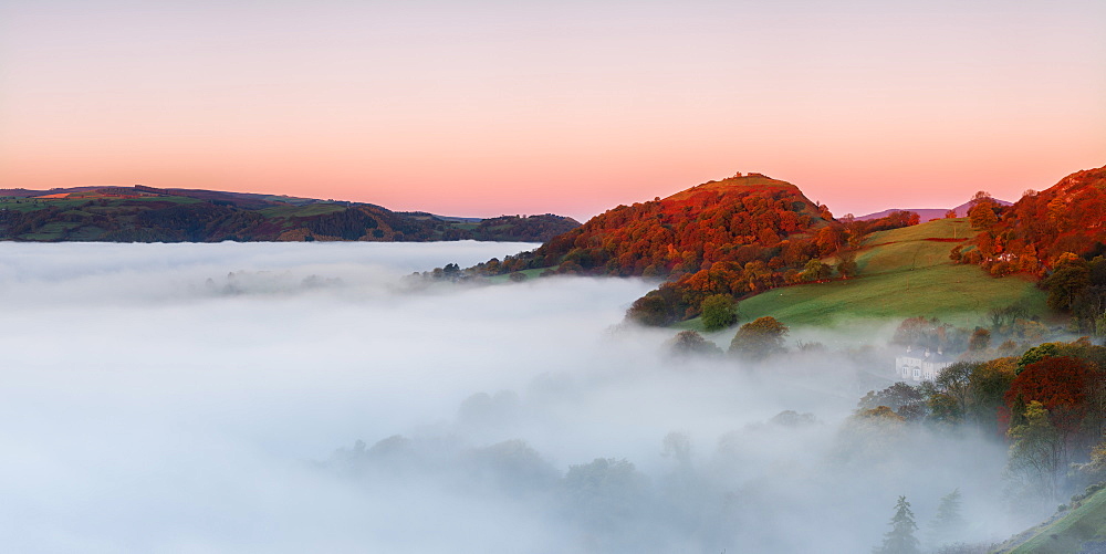 The medieval castle Dinas Bran perched above the cloud inversion lying in the River Dee valley on a clear autumn morning, Denbighshire, Wales, United Kingdom, Europe