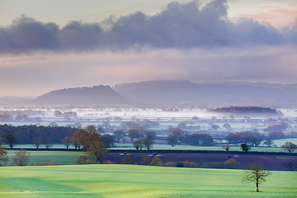 Low winter light rakes across the Cheshire plain with Beeston Castle and the Peckforton sandstone ridge beyond, Cheshire, England, United Kingdom, Europe