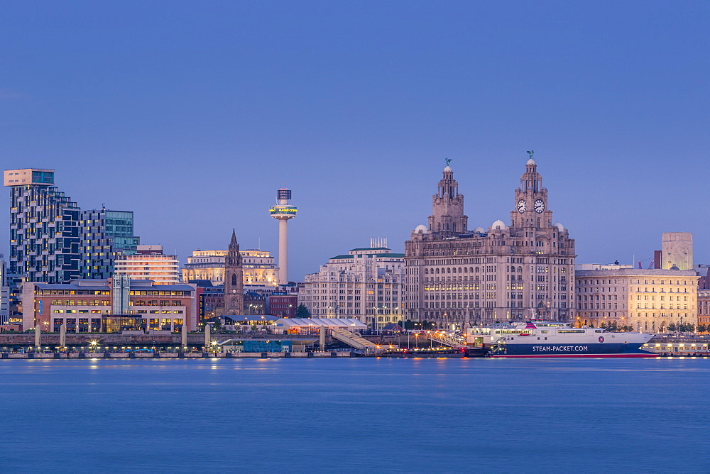 Looking across the River Mersey to the Liverpool skyline and Liver buildings at dusk, Liverpool, Merseyside, England, United Kingdom, Europe