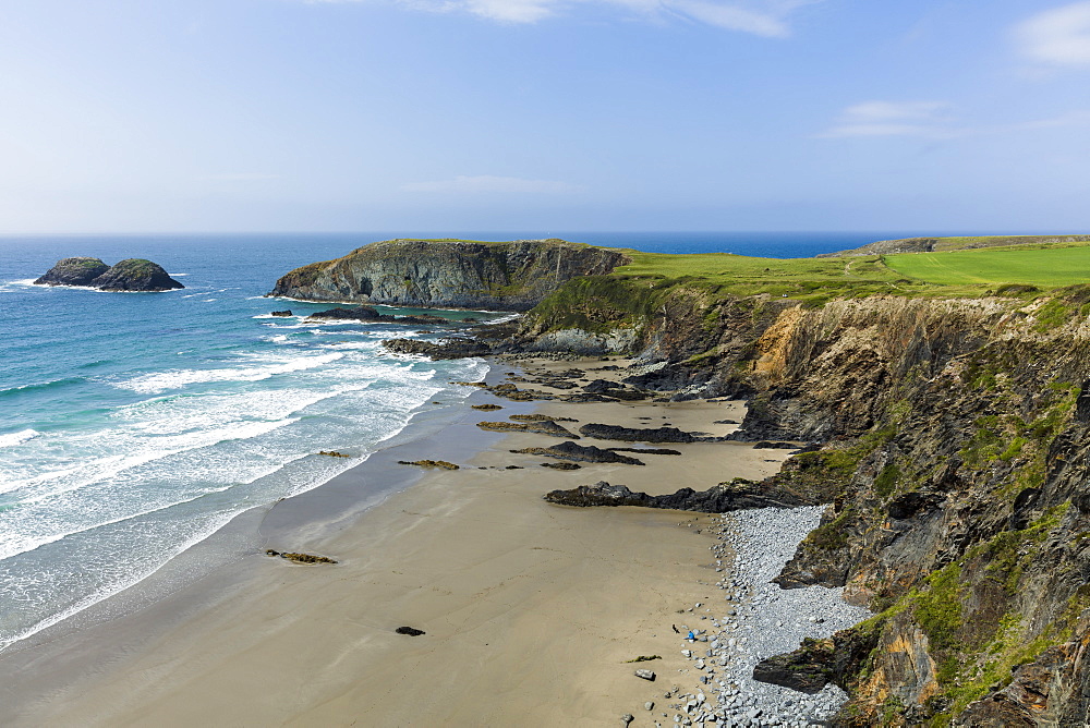 A beach along the Pembrokeshire Coast National Park with the coastal path running along the cliff tops above, Wales, United Kingdom, Europe