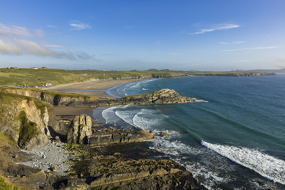 Waves gently roll into Whitesands Bay (Porth Mawr) on a summers evening along the Pembrokeshire coastal path, Wales, United Kingdom, Europe