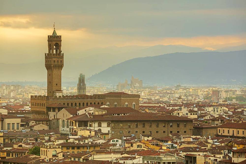 Looking across the rooftops of central Florence to The Palazzo Vecchio and the distant Apennine mountains, Florence, Tuscany, Italy, Europe