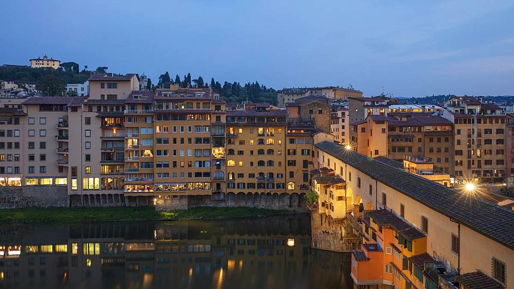 Looking across the Ponte Vecchio to the Oltrarno region of Florence lit in early evening light, Florence, Tuscany, Italy, Europe