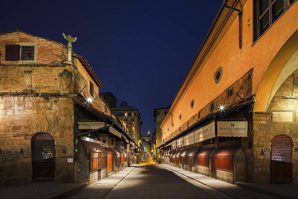 Looking along a deserted Ponte Vecchio to the Duomo in the early morning half light, Florence, Tuscany, Italy, Europe