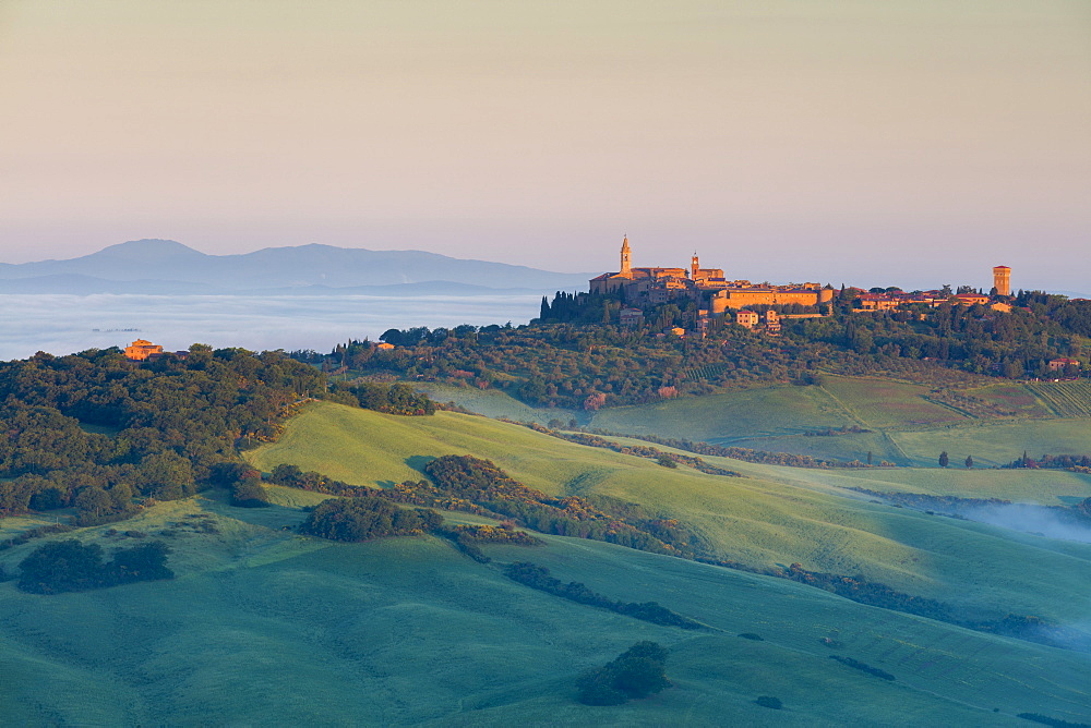 First light of the day hits the historic town of Pienza with cloud covering the Val d'Orcia beyond, UNESCO World Heritage Site, Tuscany, Italy, Europe