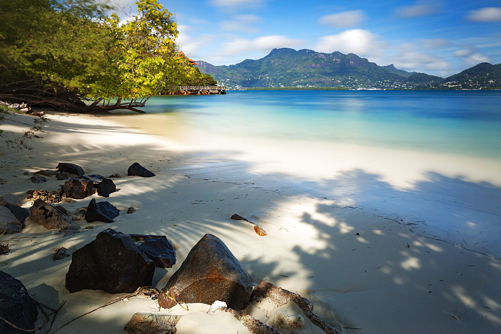 A deserted Seychelles beach with the calm still waters of the Indian Ocean beyond, Seychelles, Indian Ocean, Africa