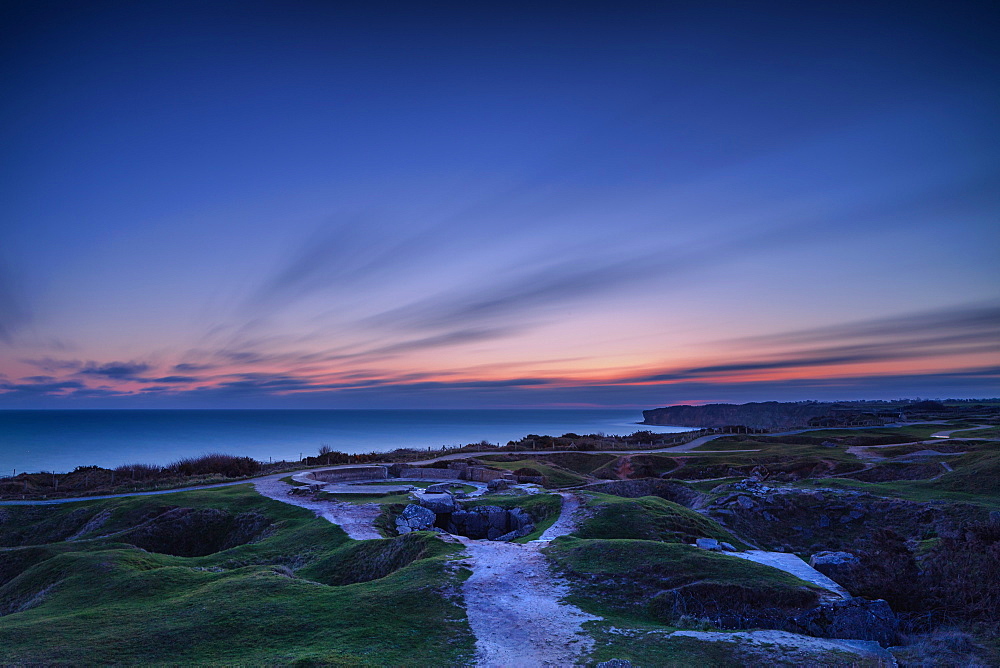 Pointe Du Hoc and its crater filled terrain with dawn breaking over the English Channel, Normandy, France, Europe