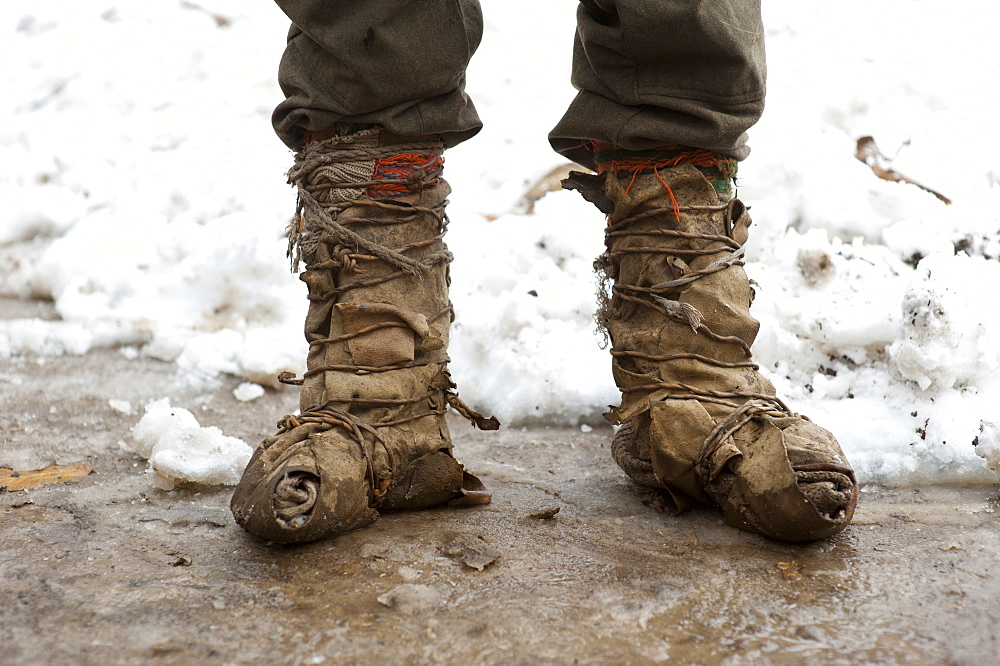 A Kalasha shepherd wears boots made from goat skin, North West Frontier Province, Pakistan, Asia