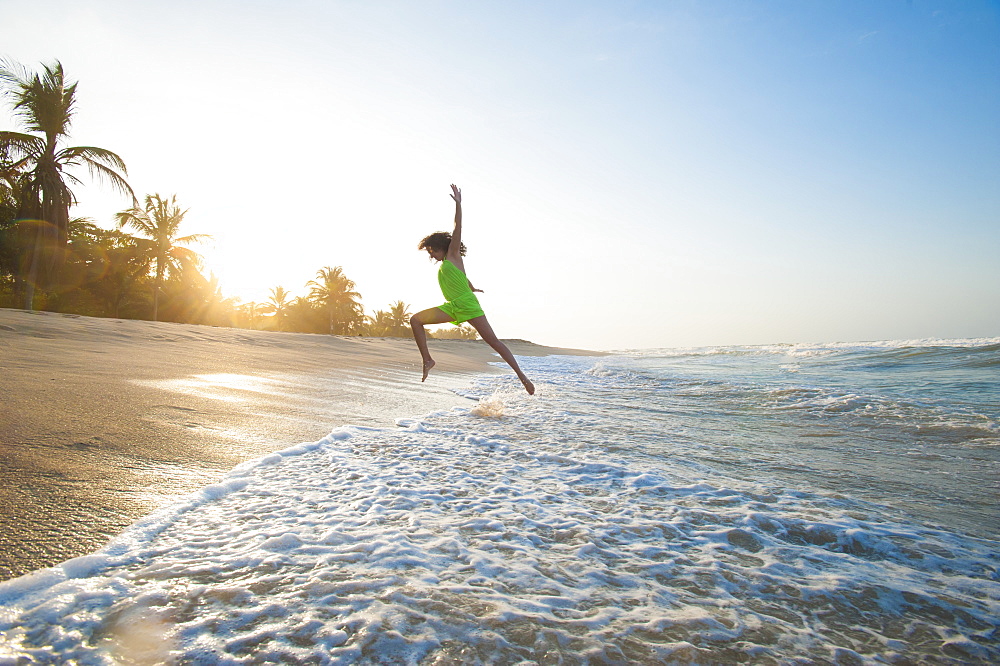 A girl plays in the waves at Palomino on the Caribbean coast of Colombia, South America