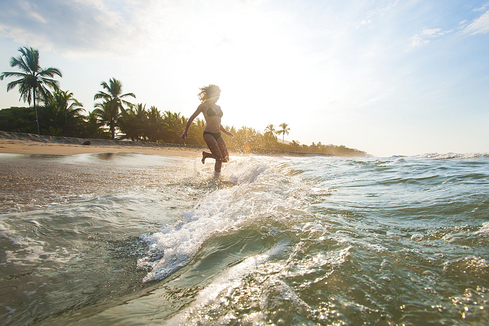 A girl plays in the waves at Palomino on the Caribbean coast of Colombia, South America