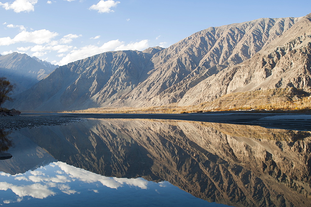 The crystal clear Shyok River creates a mirror image in the Khapalu valley near Skardu, Gilgit-Baltistan, Pakistan, Asia