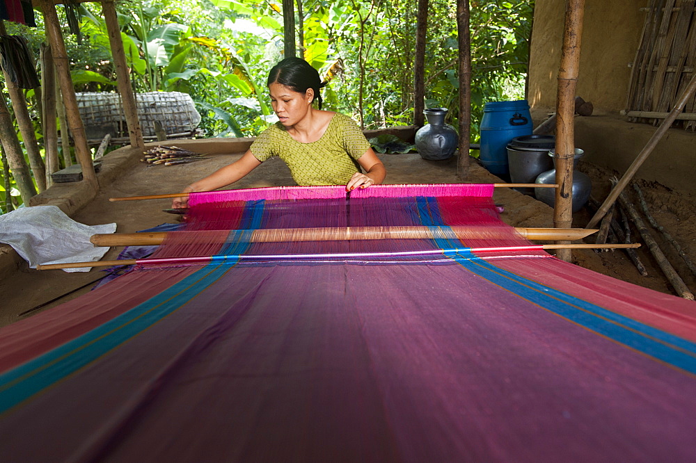 A woman weaves traditional fabric using a hand loom, Chittagong Hill Tracts, Bangladesh, Asia