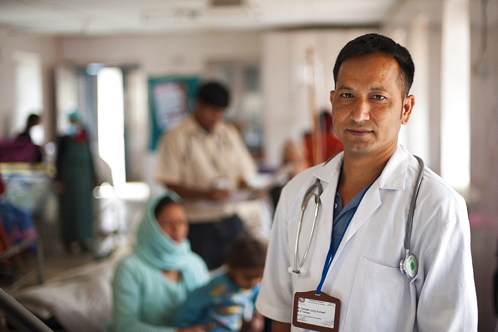 Two doctors review a patient's chart in a ward in Dadeldhura hospital in Nepal, Asia